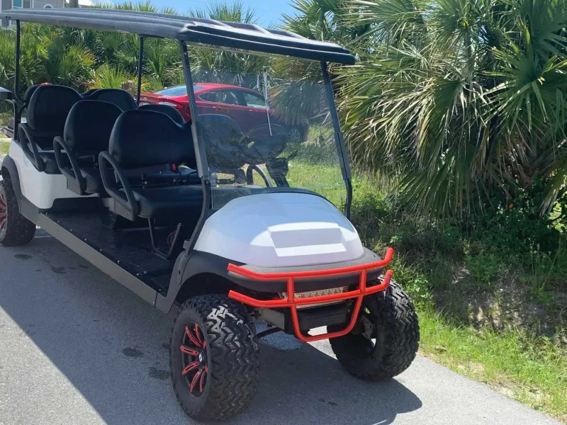 White 8-passenger stretch golf cart with red wheels